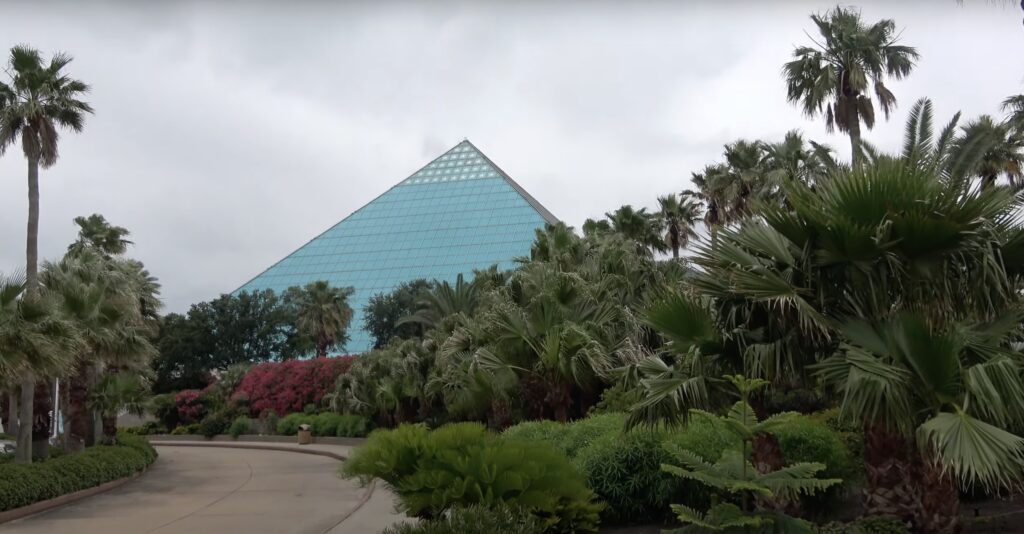Glass blue pyramid building near trees