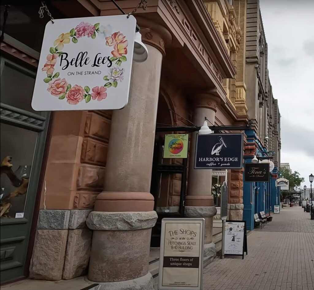 Shops and boutiques along The Strand in historic downtown Galveston, Texas, featuring Belle Lees, Harbor’s Edge, and other local favorites — a must-visit shopping destination for cruise passengers and tourists.