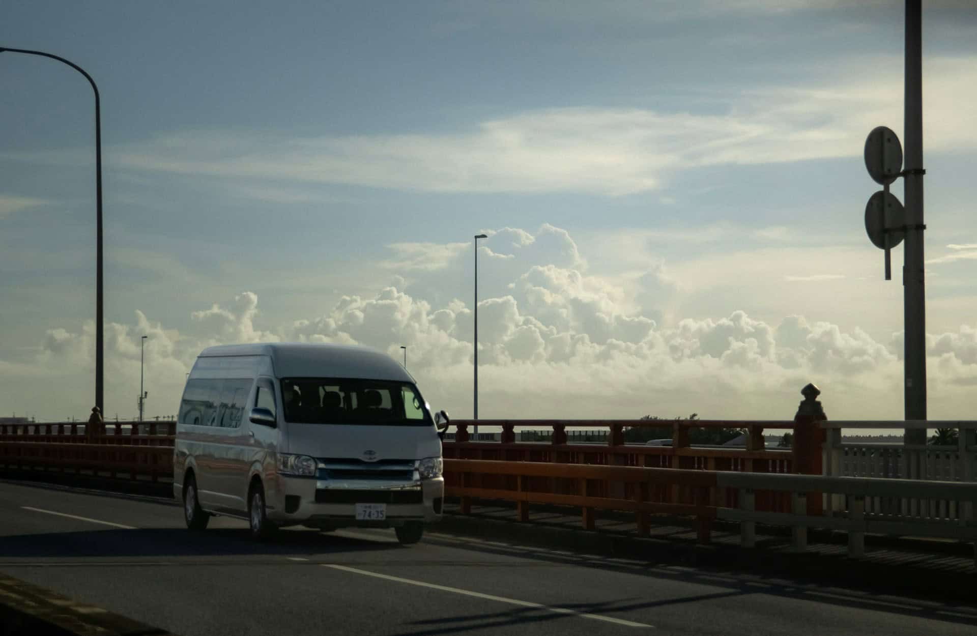 White van driving along the road